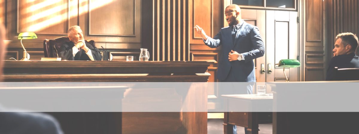 Court of Law Trial in Session: Portrait of Charismatic Male Public Defender Making Touching, Passionate Speech to Judge and Jury. Attorney Lawyer Protecting Client, Presenting Case.